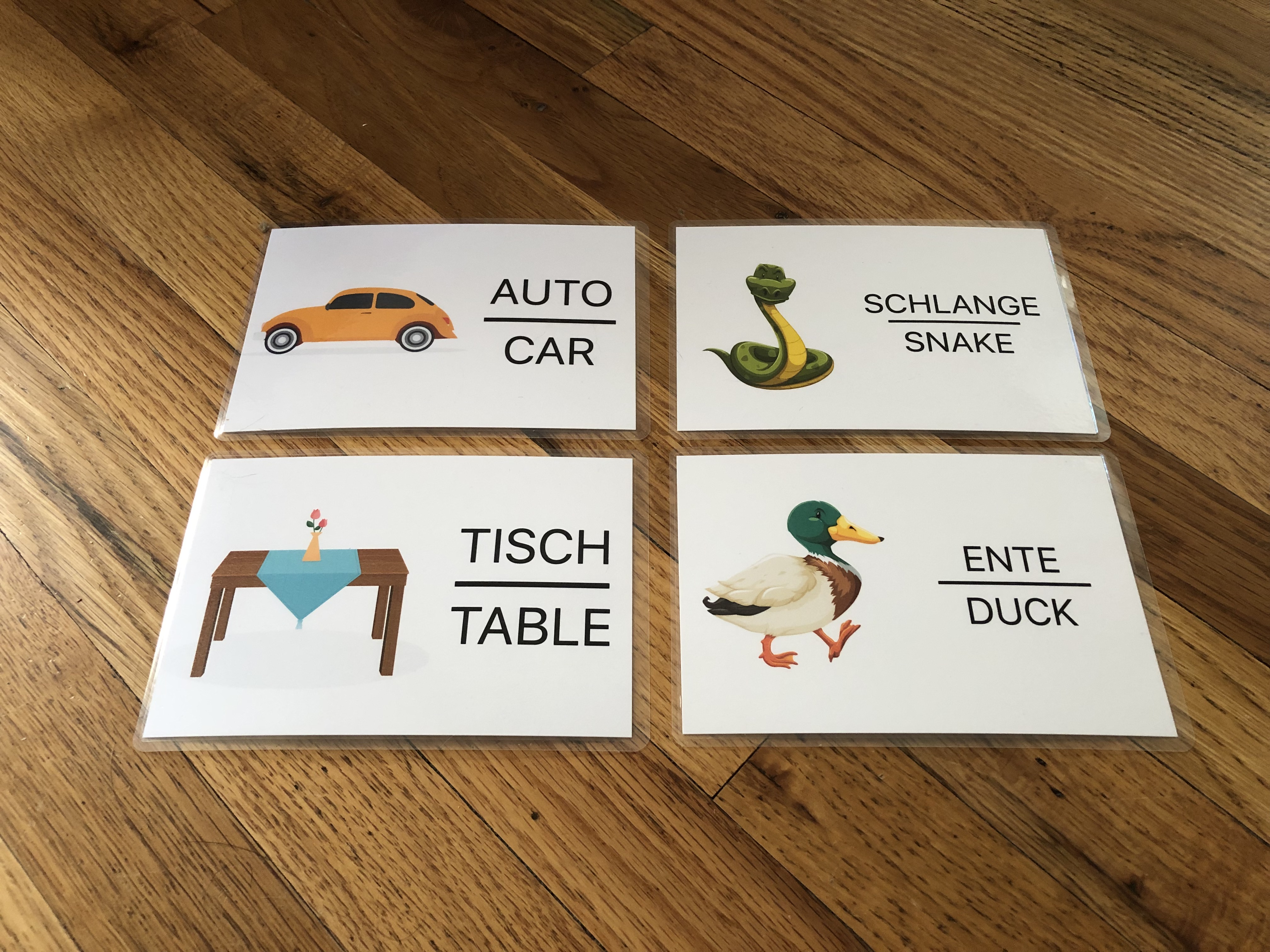 Photograph of four cards, showing symbols with their German and English translations.